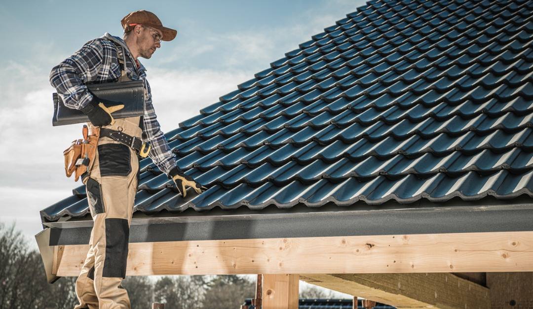 Roofer installing shingles on a residential roof